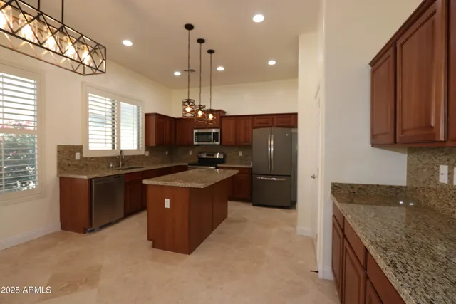 a large kitchen with a stove a sink and a refrigerator