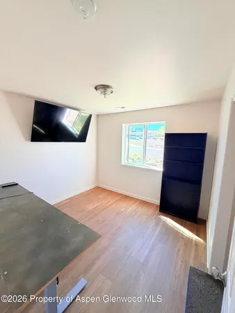 a view of a livingroom with an empty space and a window