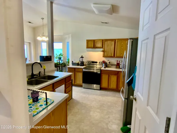 a kitchen with stainless steel appliances granite countertop a stove and a sink