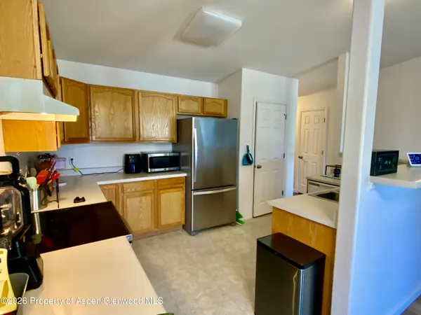 a kitchen with a refrigerator and a sink