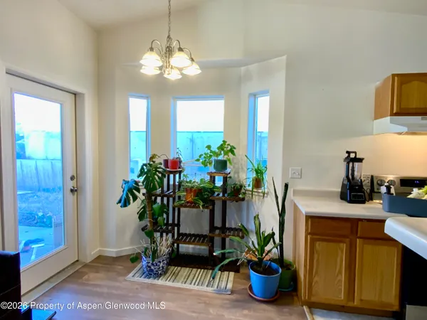 a dining room with furniture and potted plant