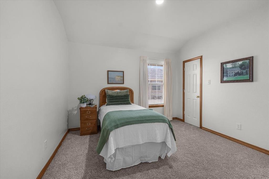 353 Hidden Meadow Court Rhome, TX 76078 - Photo 12 of 28 Bedroom featuring vaulted ceiling and light carpet