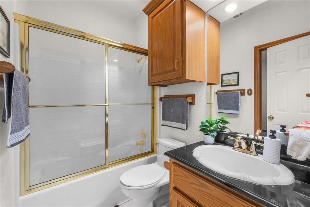 353 Hidden Meadow Court Rhome, TX 76078 - Photo 13 of 28 Bathroom with vanity and enclosed tub / shower combo