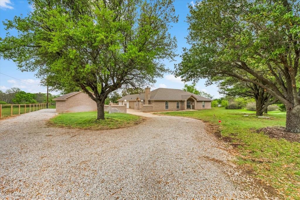 353 Hidden Meadow Court Rhome, TX 76078 - Photo 3 of 28 View of front of home featuring curved driveway, a front lawn, and a chimney