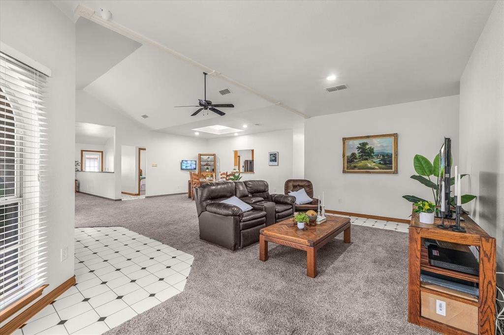 353 Hidden Meadow Court Rhome, TX 76078 - Photo 5 of 28 Carpeted living room with ceiling fan and vaulted ceiling