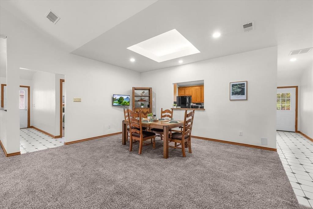353 Hidden Meadow Court Rhome, TX 76078 - Photo 6 of 28 Dining space featuring a skylight, light colored carpet, and recessed lighting