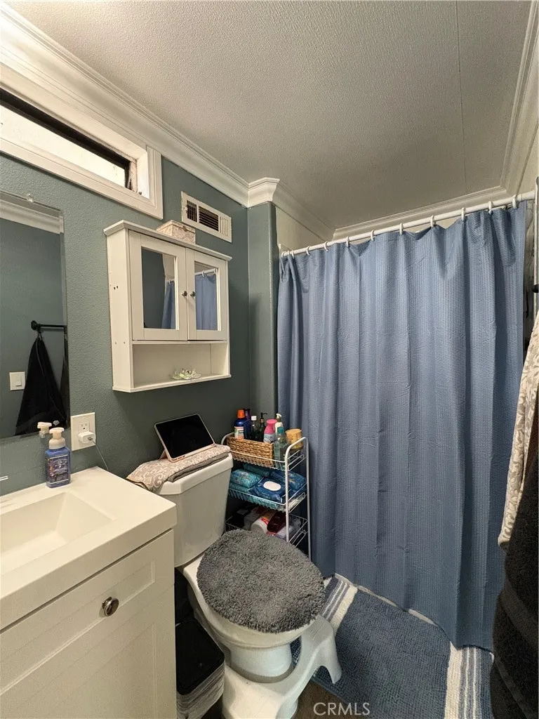 23500 The Old Road, Unit 37 Newhall, CA 91321 - Photo 11 of 22 a bathroom with a sink and a toilet