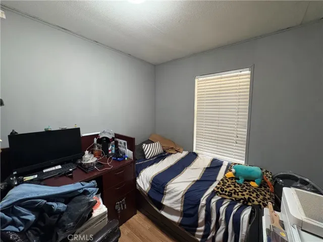 a bedroom with a bed and two windows