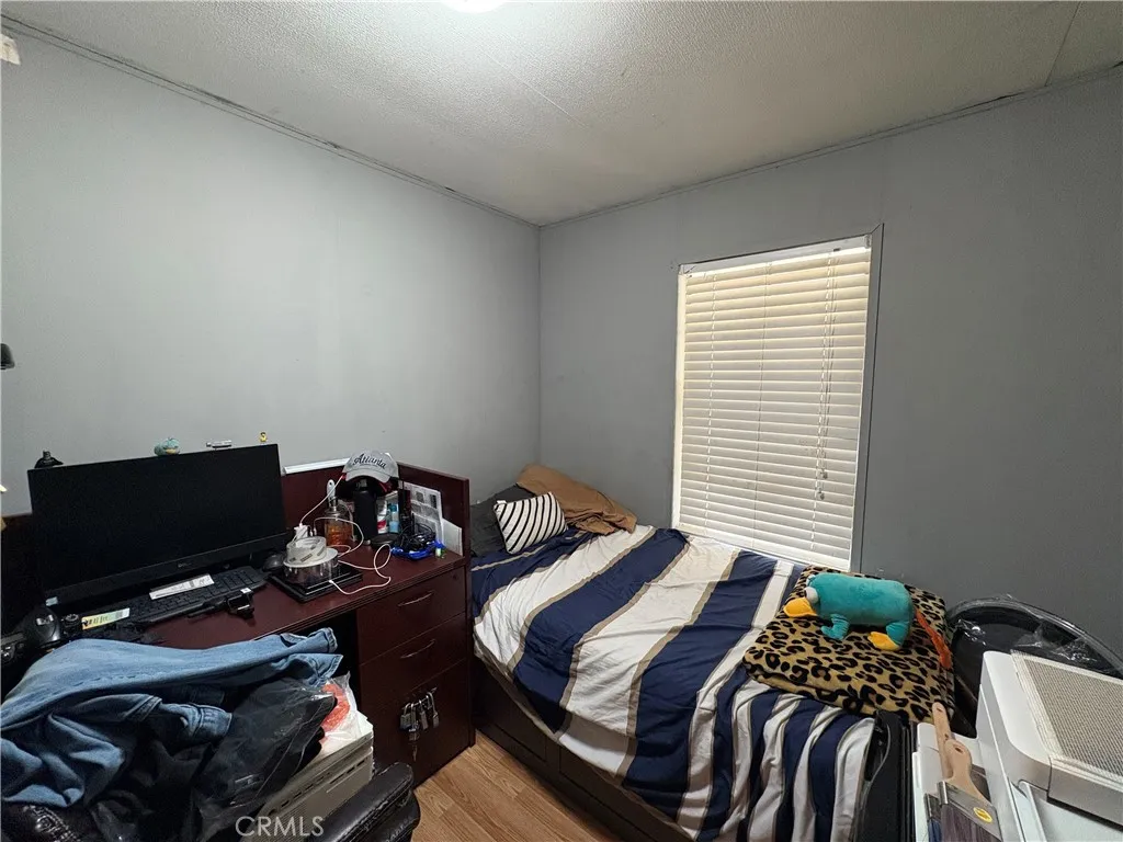 23500 The Old Road, Unit 37 Newhall, CA 91321 - Photo 16 of 22 a bedroom with a bed and two windows