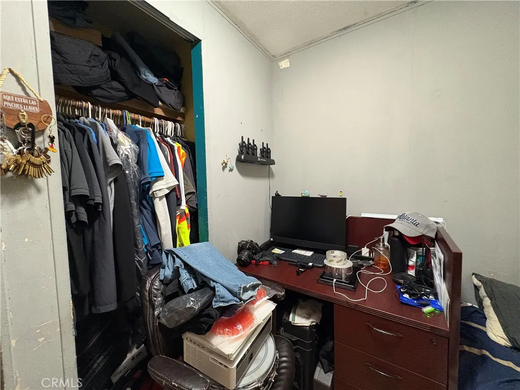 23500 The Old Road, Unit 37 Newhall, CA 91321 - Photo 17 of 22 a view of walk in closet with clothes and shoes