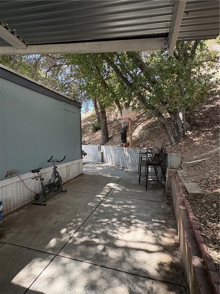 23500 The Old Road, Unit 37 Newhall, CA 91321 - Photo 18 of 22 a backyard of a house with table and chairs