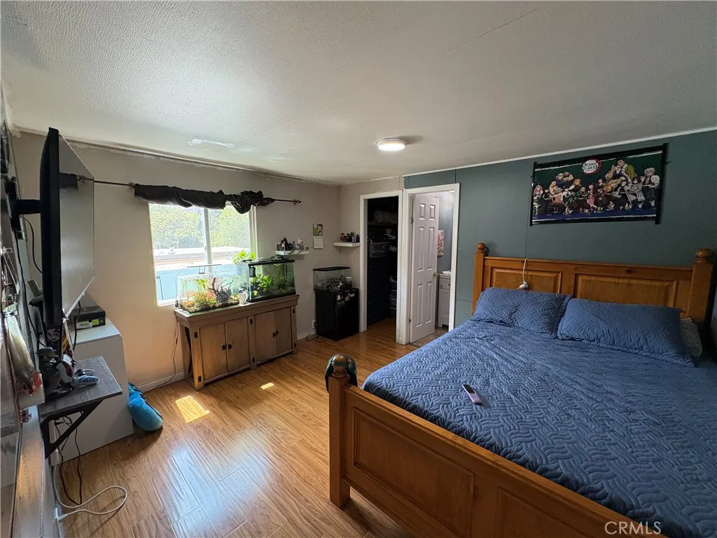 23500 The Old Road, Unit 37 Newhall, CA 91321 - Photo 9 of 22 a living room with stainless steel appliances kitchen island granite countertop furniture and a flat screen tv
