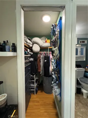 a view of a hallway with workspace and living room