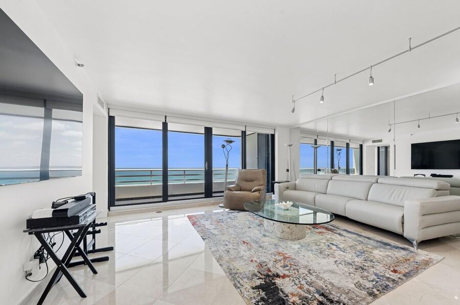 1400 South Ocean Boulevard, Unit 1004 Boca Raton, FL 33432 - Photo 1 of 55 a living room with furniture and a flat screen tv