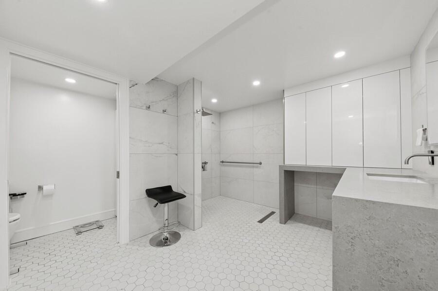 1400 South Ocean Boulevard, Unit 1004 Boca Raton, FL 33432 - Photo 13 of 55 a bathroom with a sink a toilet and a shower