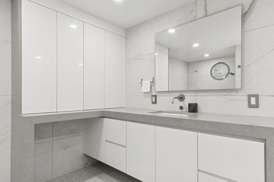 1400 South Ocean Boulevard, Unit 1004 Boca Raton, FL 33432 - Photo 14 of 55 a kitchen with a sink and cabinets