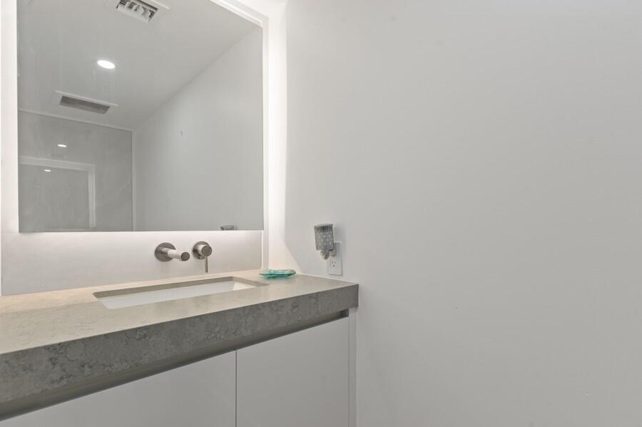 1400 South Ocean Boulevard, Unit 1004 Boca Raton, FL 33432 - Photo 18 of 55 a bathroom with a sink and a mirror