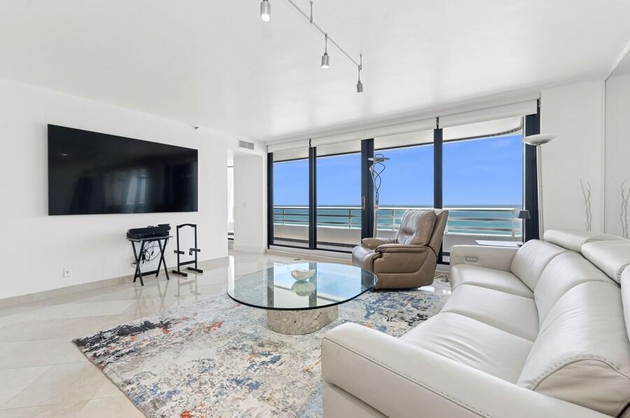 1400 South Ocean Boulevard, Unit 1004 Boca Raton, FL 33432 - Photo 3 of 55 a living room with furniture and a flat screen tv
