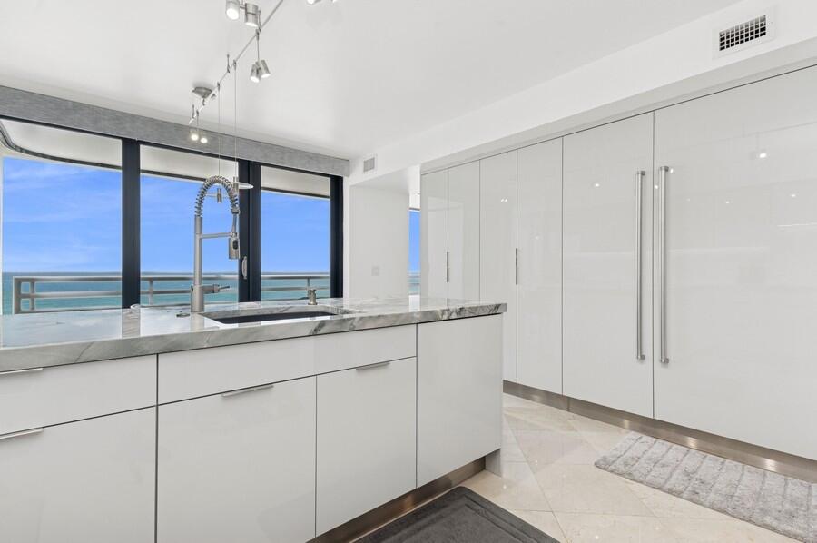1400 South Ocean Boulevard, Unit 1004 Boca Raton, FL 33432 - Photo 9 of 55 a bathroom with double vanity and a two mirror window