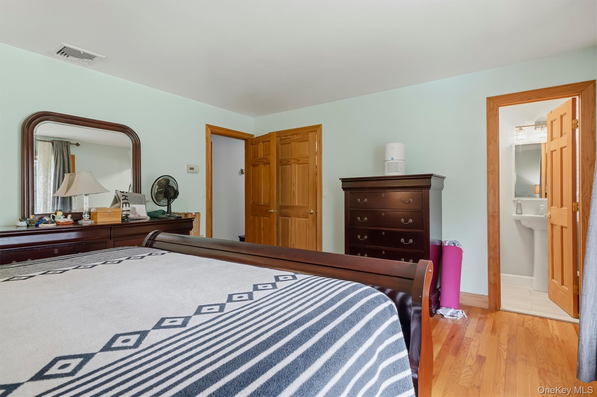 318 Beattie Road Washingtonville, NY 10992 - Photo 17 of 42 a bedroom with a bed and a flat screen tv