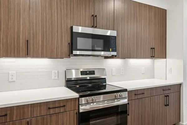 a kitchen with a sink cabinets and wooden floor