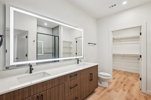 a bathroom with a double vanity sink and mirror