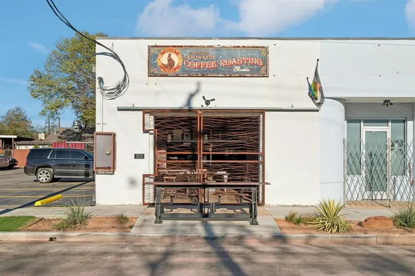 a view of a patio with a table and chairs and potted plants