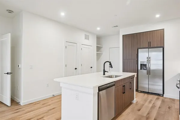 a kitchen with kitchen island a sink stove and refrigerator