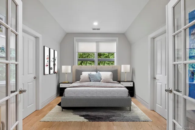 a bedroom with a large bed and a window