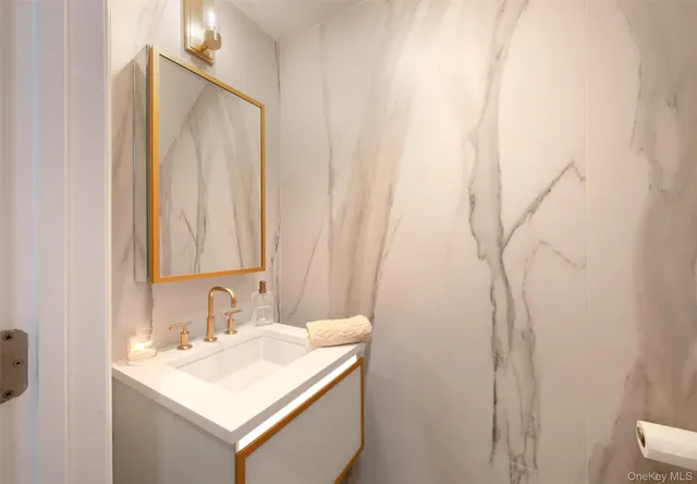 a bathroom with a sink vanity and a mirror