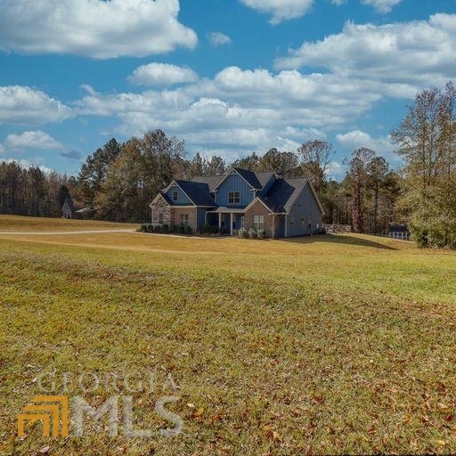 311 Rising Star Church Road Jackson, GA 30233 - Photo 1 of 1 a view of a lake with a house in the background