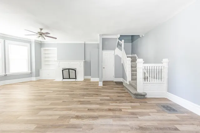 a view of an empty room with a fireplace