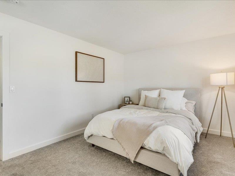 4475 Diamond Street, Unit 3 Capitola, CA 95010 - Photo 16 of 25 a bedroom with a bed and a lamp