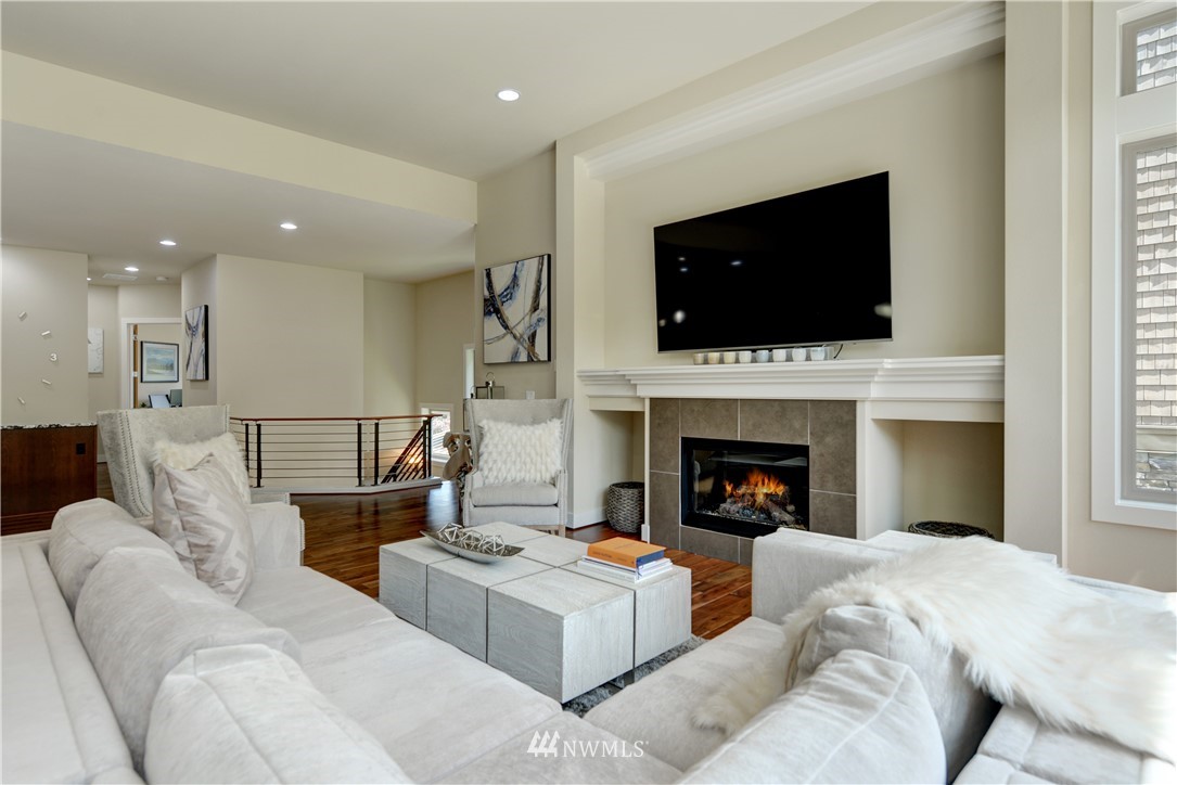 1105 North 41st Place Renton, WA 98056 - Photo 12 of 40 a living room with furniture a flat screen tv and a fireplace