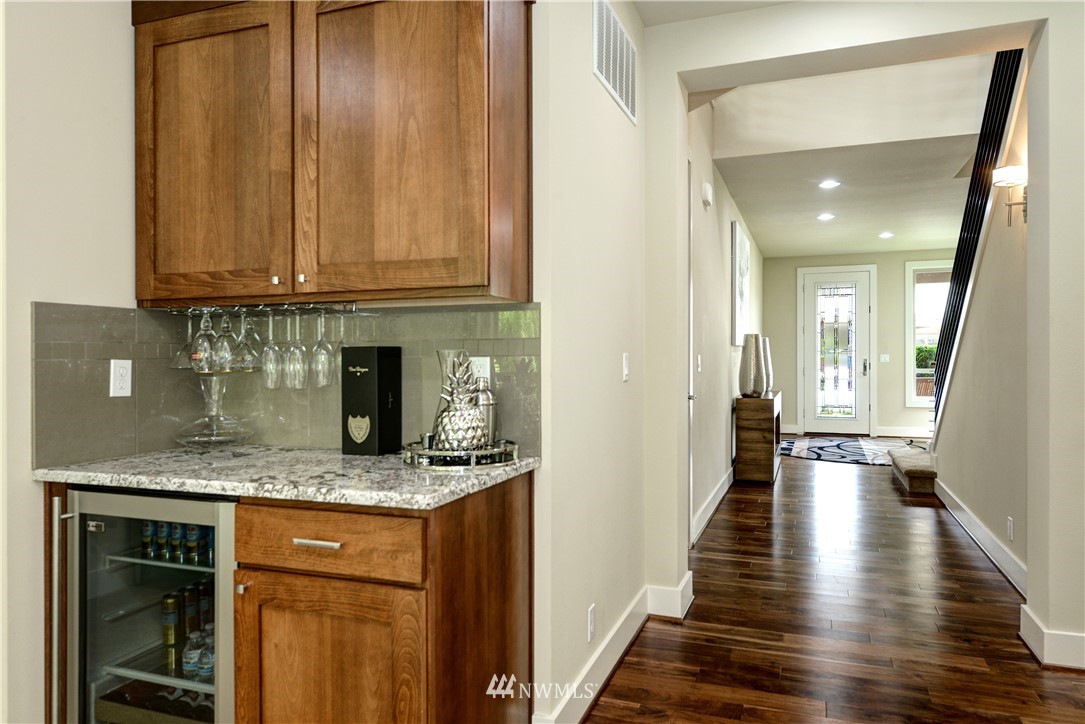 1105 North 41st Place Renton, WA 98056 - Photo 20 of 40 a kitchen with granite countertop a sink a stove and cabinets