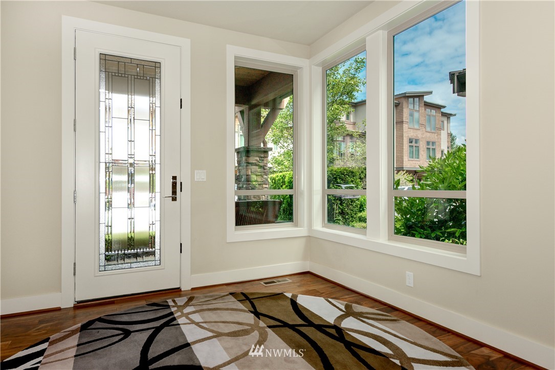 1105 North 41st Place Renton, WA 98056 - Photo 3 of 40 a view of a room with a large window and wooden floor