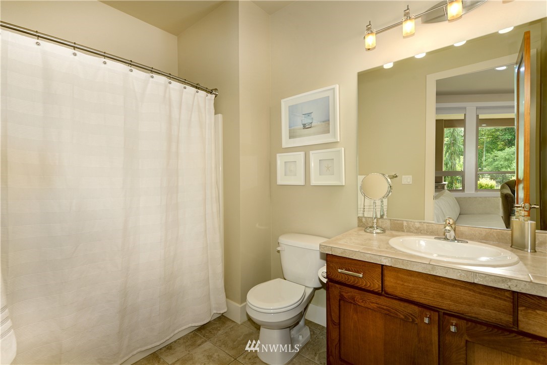 1105 North 41st Place Renton, WA 98056 - Photo 24 of 40 a bathroom with a toilet sink and mirror