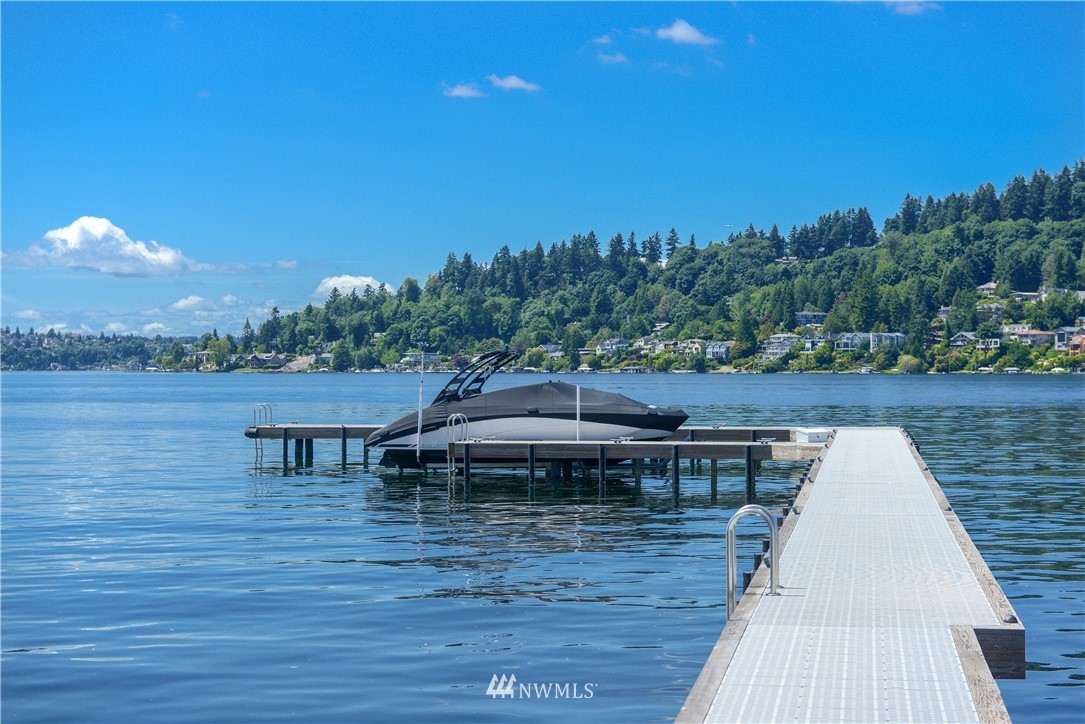 1105 North 41st Place Renton, WA 98056 - Photo 35 of 40 a view of a roof deck with table and chairs a barbeque with wooden floor and fence