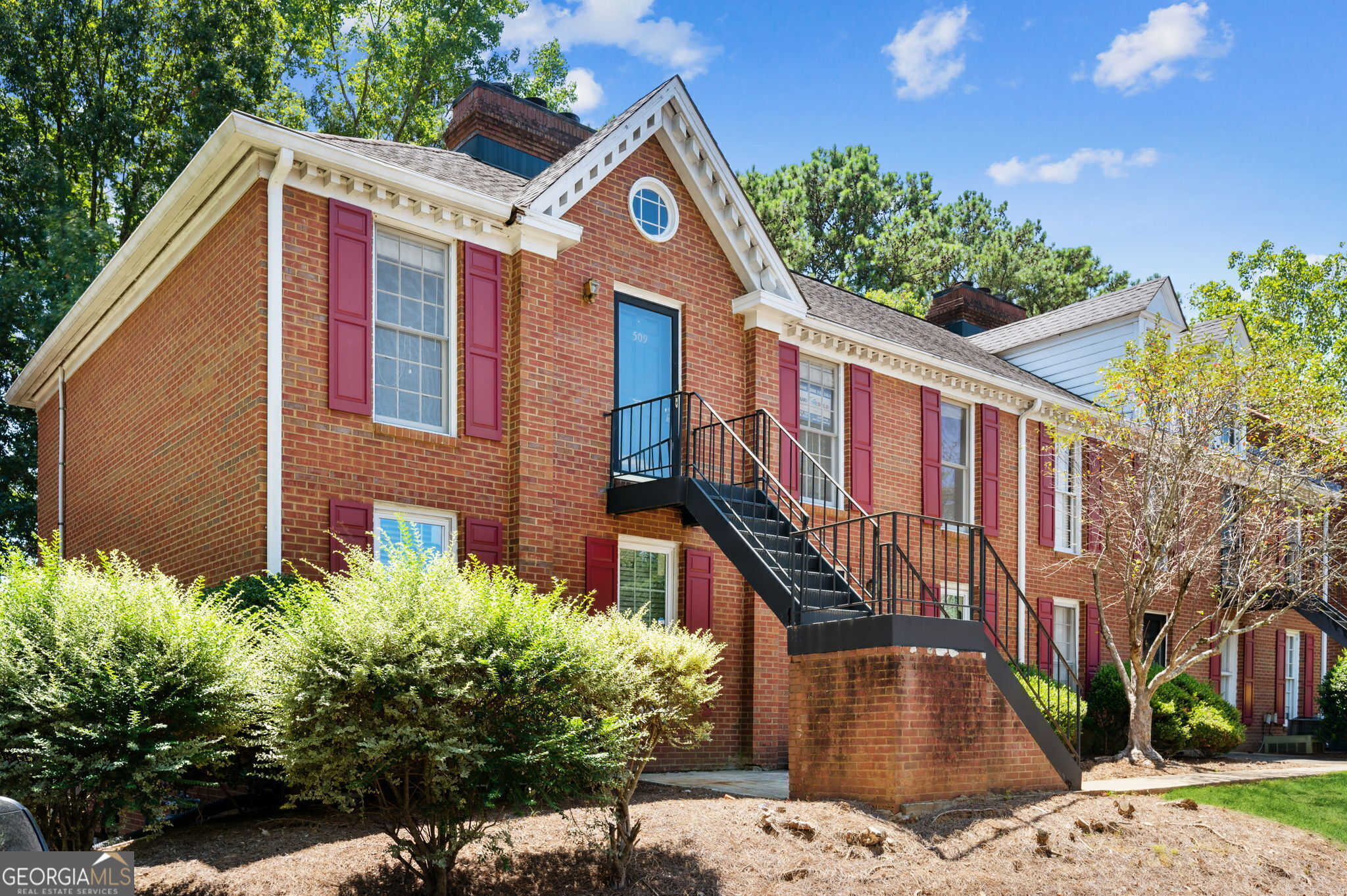 1166 Booth Road Southwest, Unit 509 Marietta, GA 30008 - Photo 1 of 1 a front view of a house with a yard