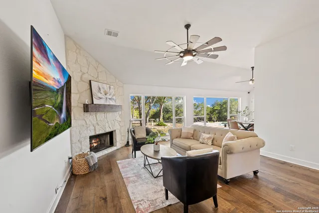 a living room with furniture fireplace and a flat screen tv