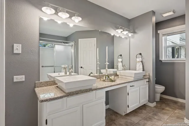 a bathroom with a sink double vanity and a mirror