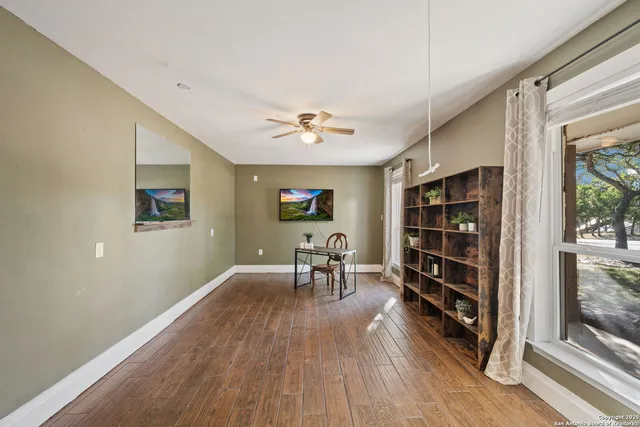 wooden floor in an empty room with a window