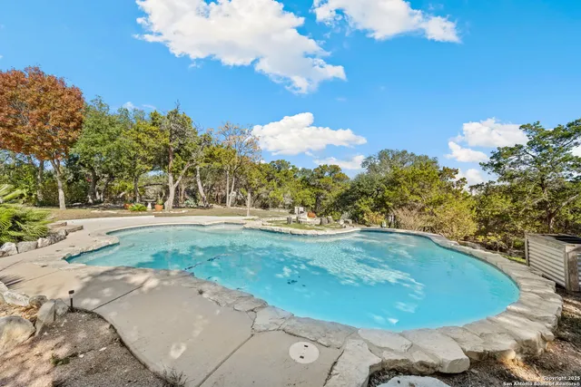 a view of a swimming pool with a yard