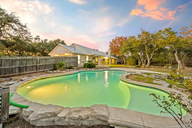 a view of a swimming pool with a patio