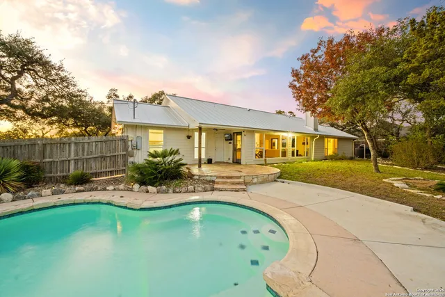 a house with swimming pool in front of it