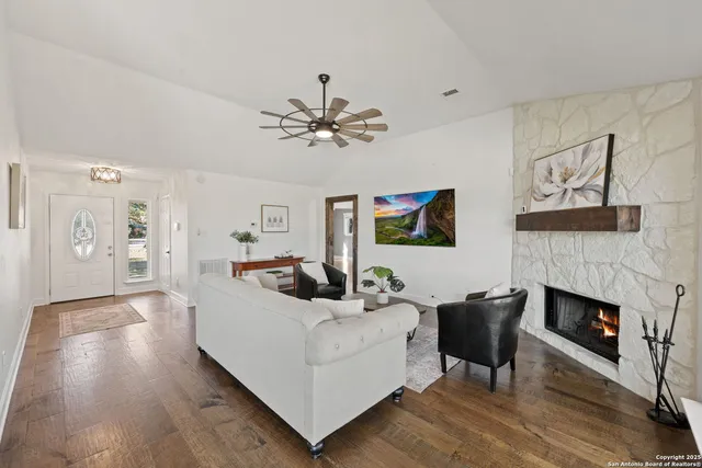 a living room with furniture and a fireplace
