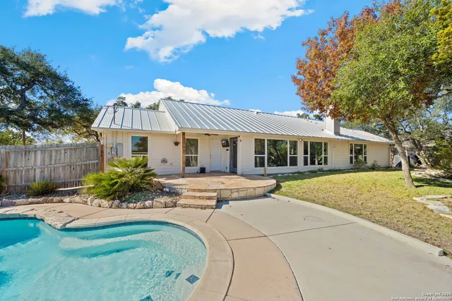 a view of a swimming pool with a patio