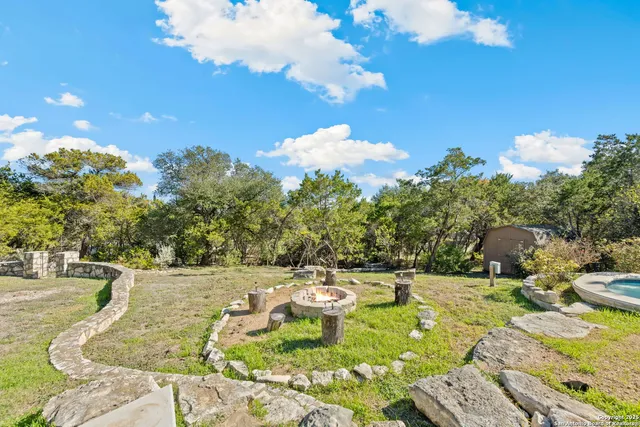 a view of a swimming pool with a yard and plants