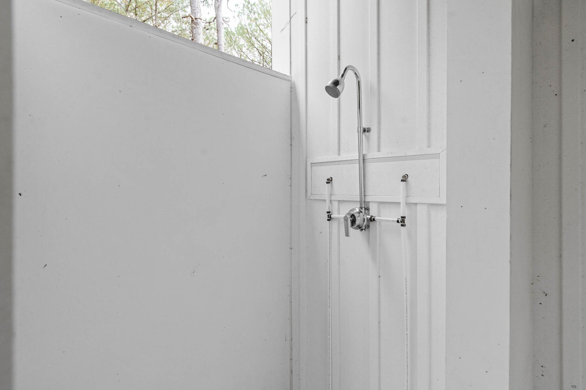 38697 Fred Hudson Road Bethany Beach, DE 19930 - Photo 11 of 51 a bathroom with a glass door shower