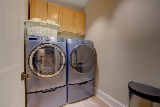 a spacious bedroom with a bed couch and window
